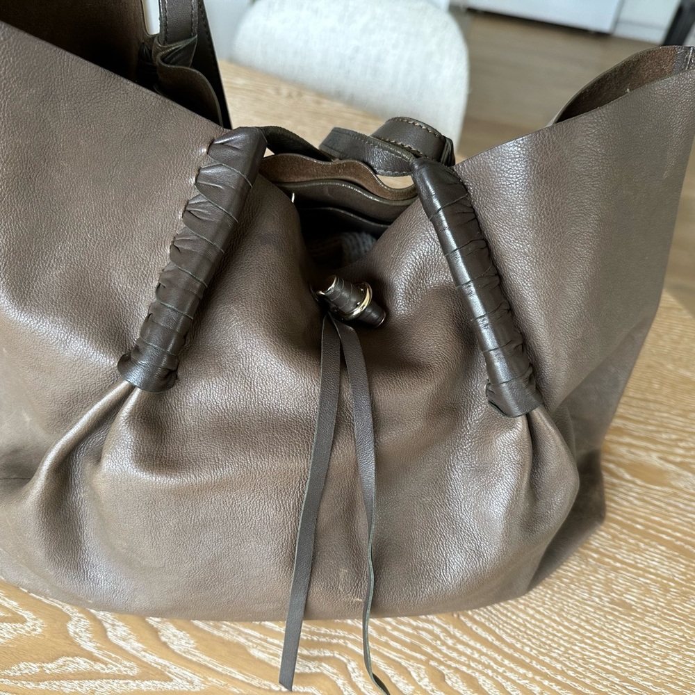 Nina Ricci medium size tote bag. Brown. It has an inside small bag. Well used.